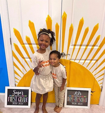 Two children smiling during a festive event at a pediatric dental office