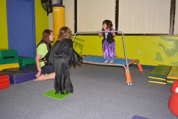 Child in costume playing during the Alexandria Children's Dentistry Halloween celebration