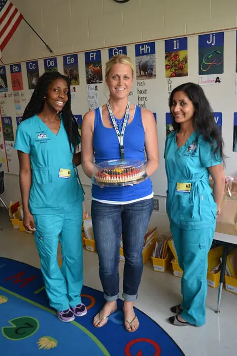 Alexandria Children's Dentistry team posing with a patient during Mother's Day celebration