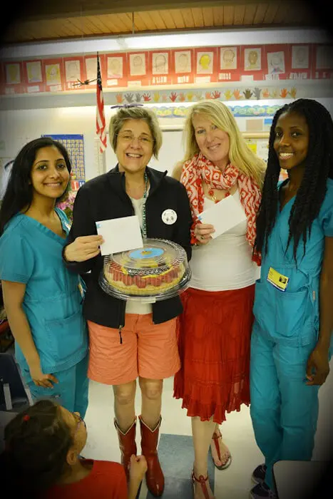 Alexandria Children's Dentistry team celebrating Mother's Day with flowers and cake