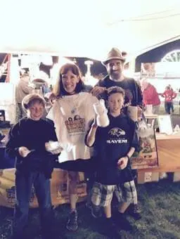 Family posing with Alexandria Children's Dentistry team at Oktober Fest community celebration