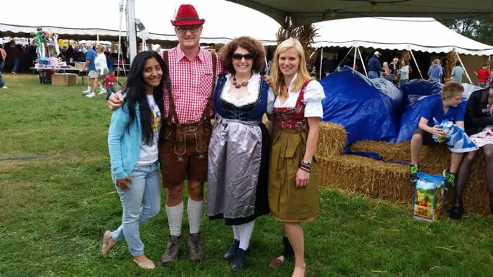 Alexandria Children's Dentistry staff posing with visitors in traditional Oktober Fest attire
