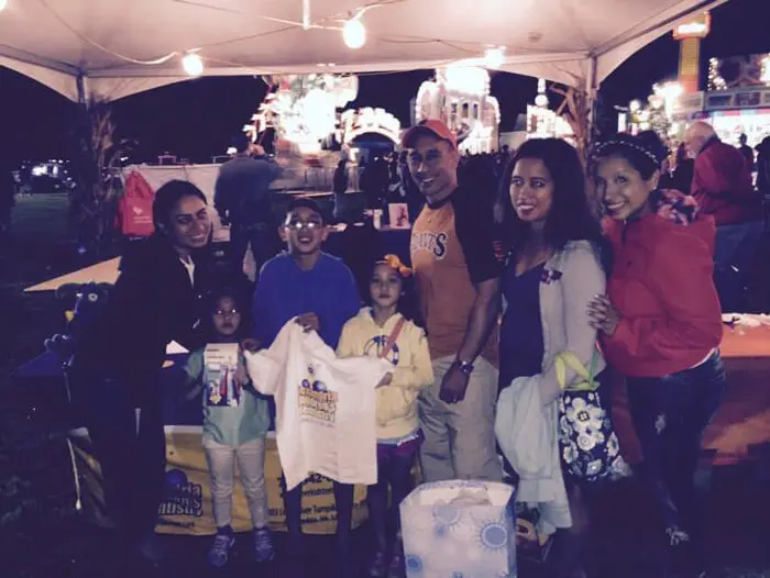 Families receiving Alexandria Children's Dentistry giveaways during Oktober Fest evening event