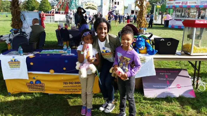 Children and family visiting the Alexandria Children's Dentistry booth at Oktober Fest
