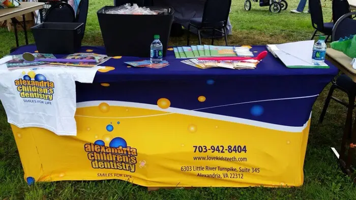 Alexandria Children's Dentistry booth display with educational materials and giveaways