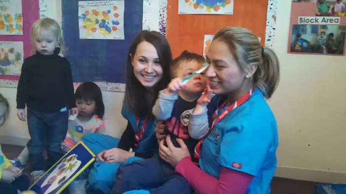 Alexandria Children's Dentistry staff helping children practice brushing techniques