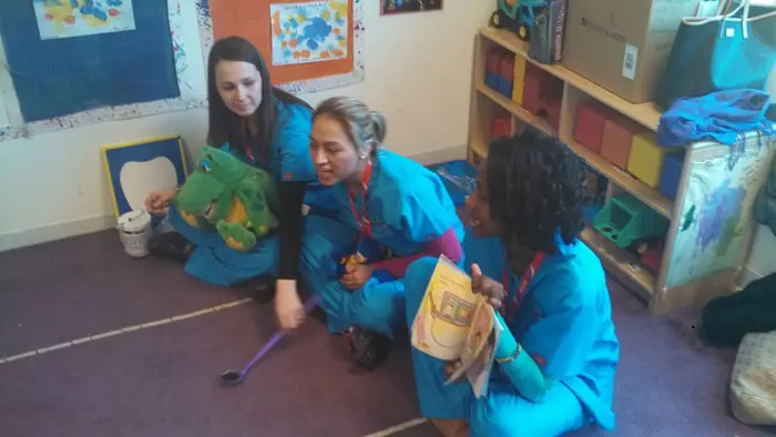 Alexandria Children's Dentistry team reading and teaching children about dental care