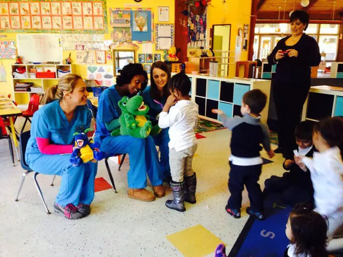 Alexandria Children's Dentistry team leading an oral health lesson in a preschool classroom