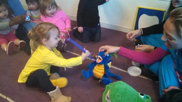 Alexandria Children's Dentistry team demonstrating proper brushing using a dental model