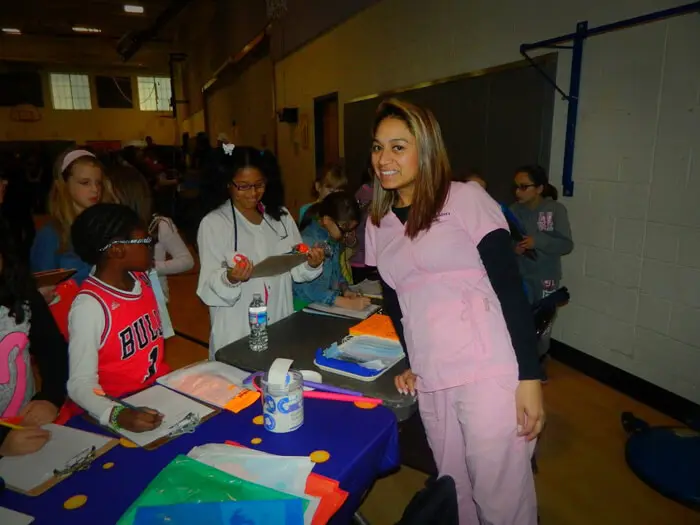 Alexandria Children's Dentistry staff welcoming families at a community school event