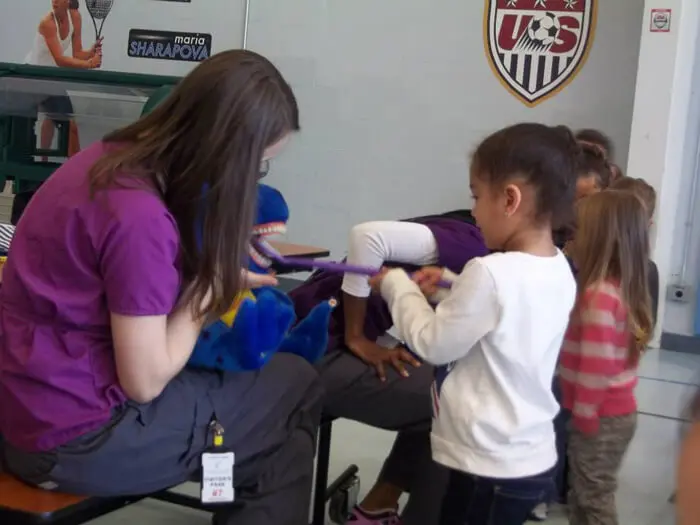 Child practicing brushing skills with guidance from Alexandria Children's Dentistry