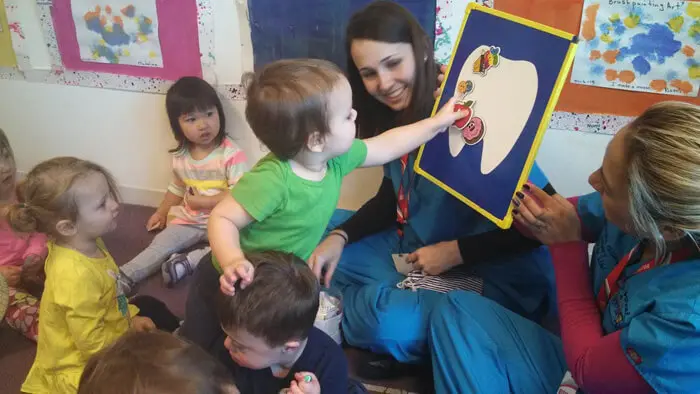 Child participating in an interactive oral health activity with Alexandria Children's Dentistry