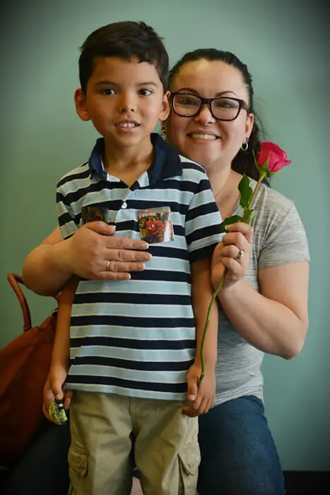 Mother and child holding a Mother's Day rose at Alexandria Children's Dentistry